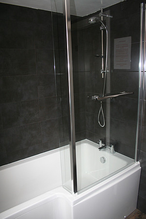 P-Shape bath with over-head shower.